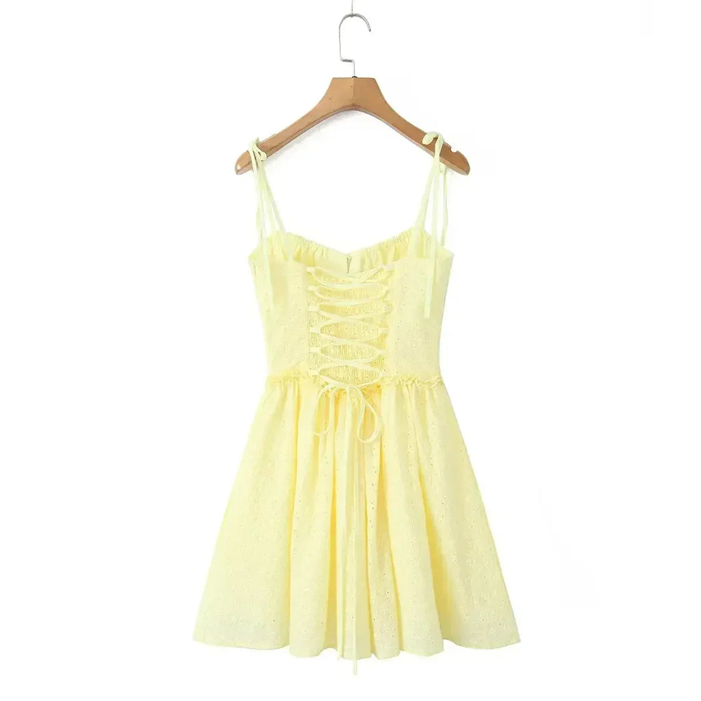 YENKYE Sexy Elegant Women Hollow Out Embroidery Yellow Sling Mini Dress Low Waist Lace Up Bandage Party Dresses Birthday Robe